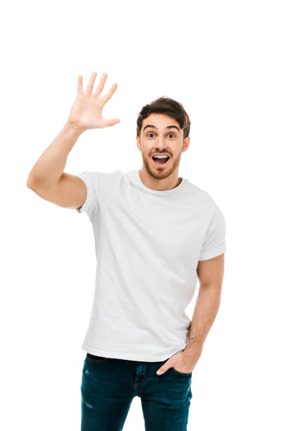 istock cheerful young man waving hand and smiling at camera isolated on white 1096008030