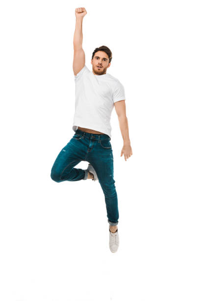 istock serious handsome man jumping with raised hand and looking at camera isolated on white 1096008064