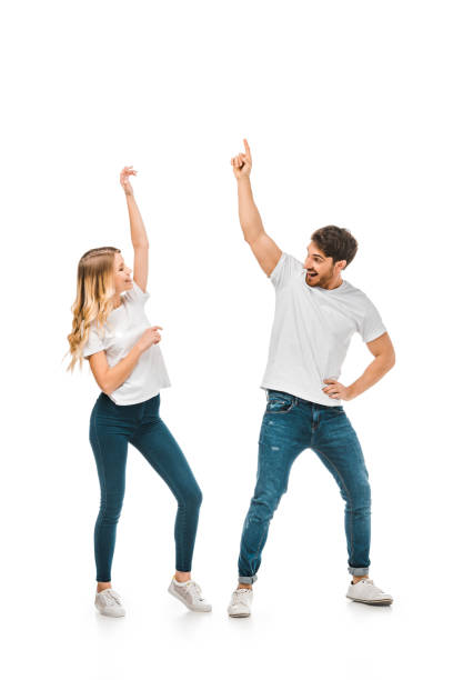 istock happy young couple dancing and smiling each other isolated on white 1096008118