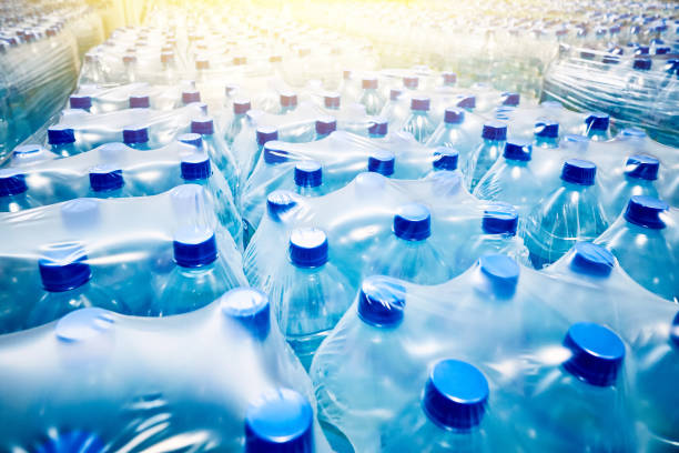 Many packaged blue mineral water bottles stock photo