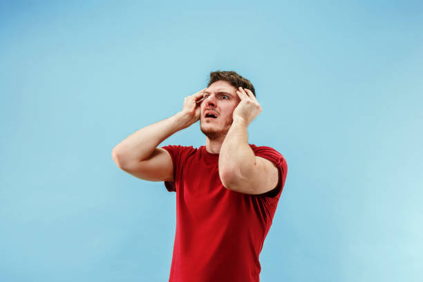 istock Young boy with a surprised expression bet slip on blue background 1096012066