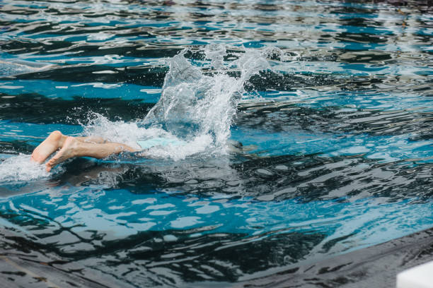 istock man dives clear transparent pool splashes resort 1096012708
