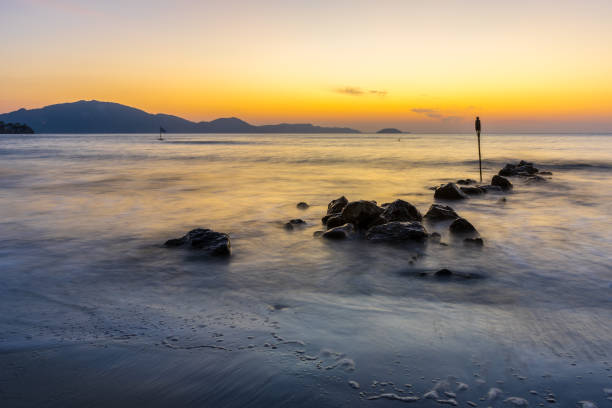 istock Romantic sunrise mood at silent ocean water and stones at beach 1096016018