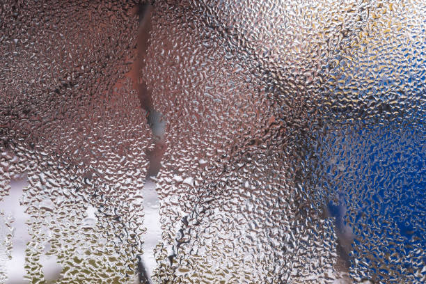 istock Water drops on glass window close up with blurred background. Drops in macro. Condensate on window closeup. Wet air. 1096017192