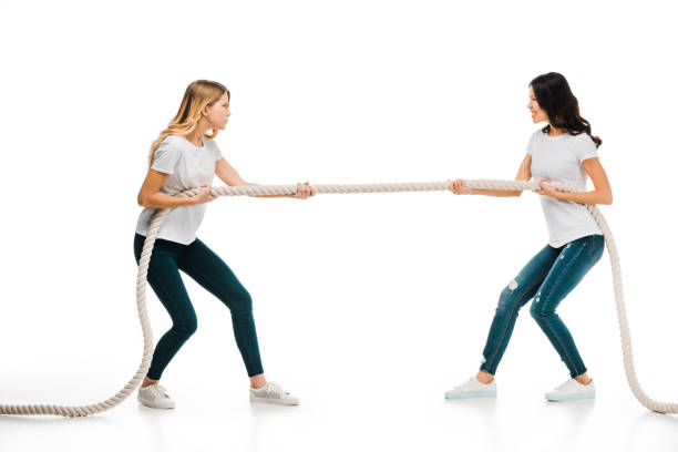 istock angry young women pulling rope and looking at each other isolated on white 1096019158