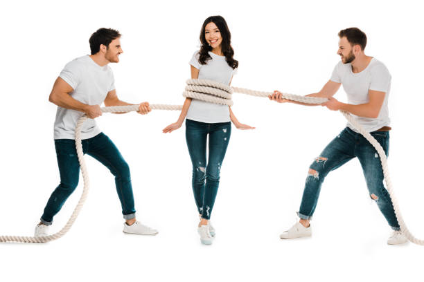 istock angry men pulling rope wrapped around smiling young woman isolated on white 1096019196