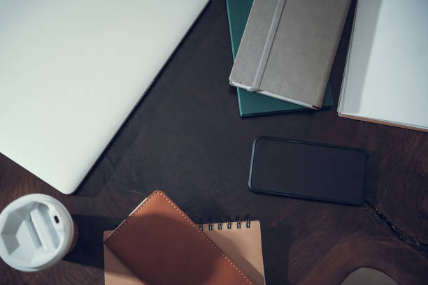 istock Top view of modern smartphone on the wooden surface with notebooks 1096021302