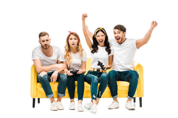 istock emotional young friends sitting on sofa and playing with joysticks isolated on white 1096023194