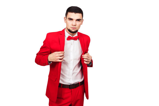 istock confident young handsome. bearded man in red suit posing on white background 1096024284
