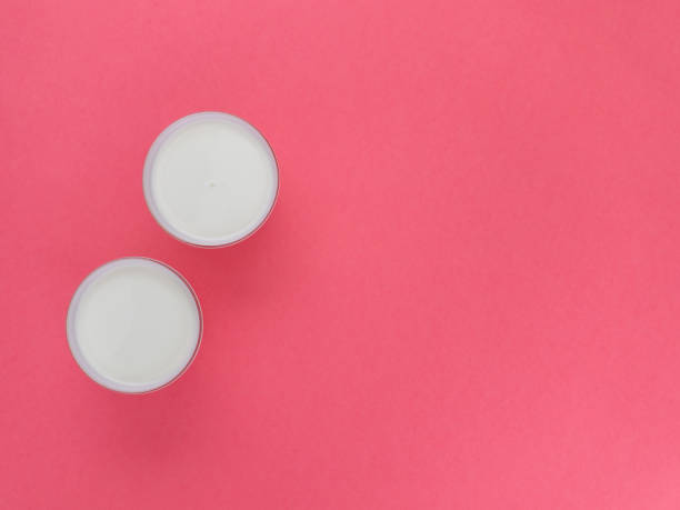 istock Healthy breakfast. Yogurt in white glasses on pink background. Copy space, flat lay, top view 1096028308
