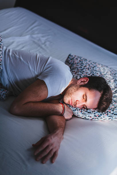 istock Young tired man waking up in bed in the morning 1096033602