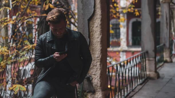 istock Blond boy looking at phone under the leaves 1096033964
