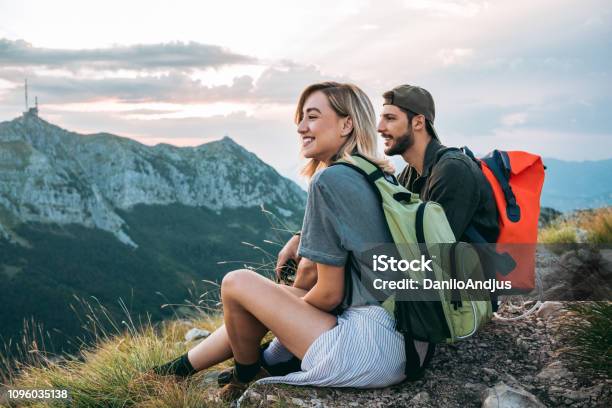 Beautiful Young Couple Relaxing After Hiking And Taking A Break Stock Photo - Download Image Now