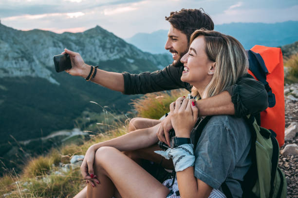 istock young couple hiking and taking a selfie 1096035578