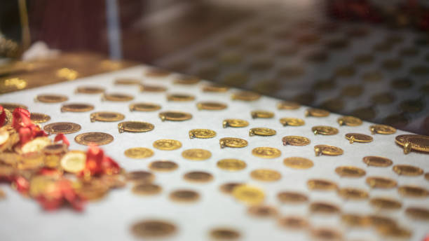 Gold coins standing on the shelf