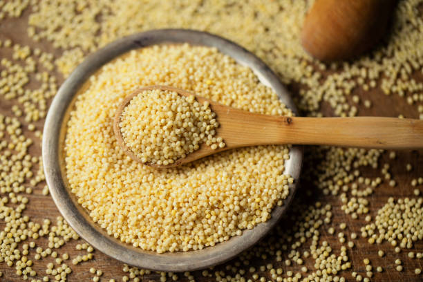 istock Millet groats in spoon above bowl, top view 1096039106