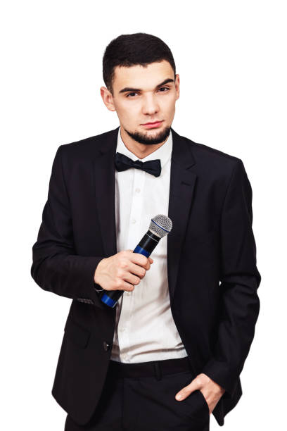 istock stylish elegant man in a black suit with a microphone in his hand 1096041184