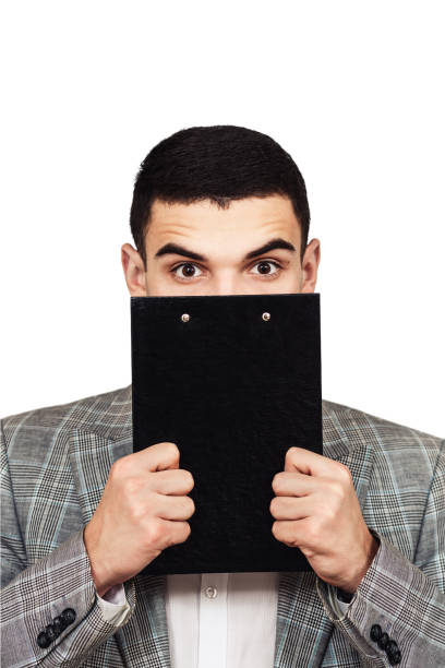 istock young stylish guy in a gray suit with a tablet in his hand. 1096041228