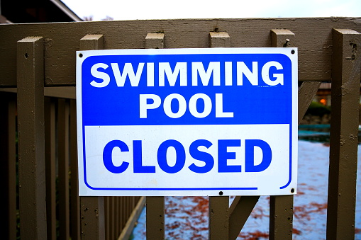 Swimming Pool Closed Sign on Safety Fence