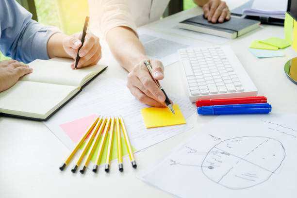 istock university / college students discussing on homework in classroom, education concept 1096048056