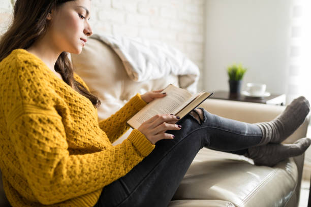 istock Woman Gaining Knowledge From Stories At Home 1096065586