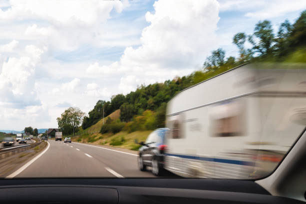 On the way to summer holiday in Tessin on the Swiss autobahn we are overtake a car with caravan trailer