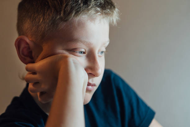 istock Lonely Sad boy thinking about something boy portrait. 1096073964