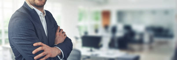 istock businessman standing on office background with arms crossed. copy space 1096077210