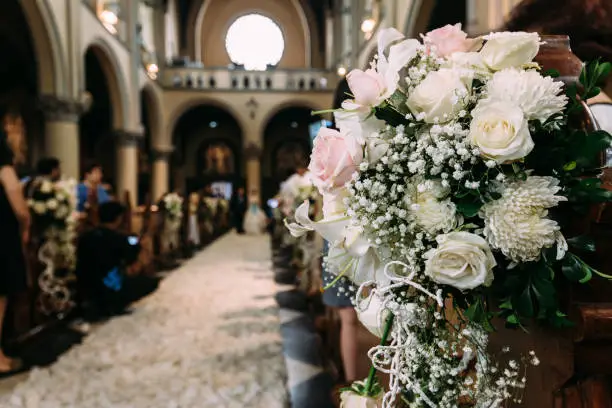 Photo of Beautiful flower bouquet decoration for wedding in a church with blur background.