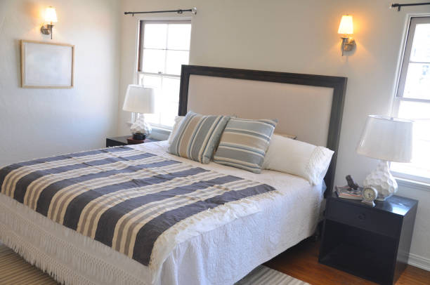 istock Made bed and nightstand in luxurious bedroom 1096080978