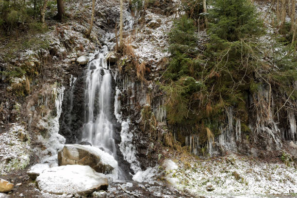 istock Icy waterfall in the frosty forest with snow 1096084888