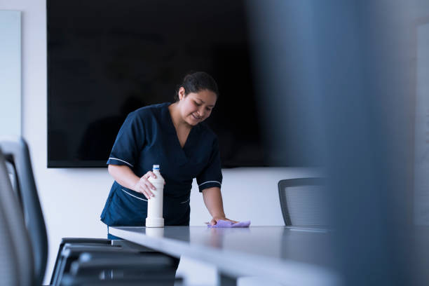 istock woman cleaning desk 1096085862