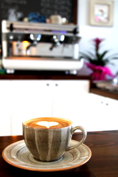 istock coffee cup with heart shape and modern coffee mashine in background 1096087328