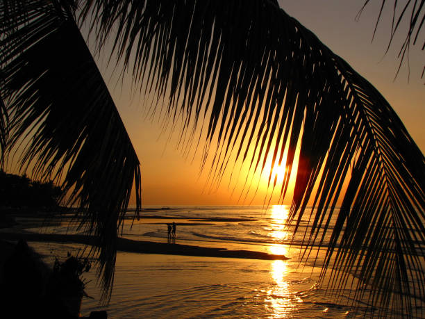 Couple in love enjoying the sunset at Lovina beach, Bali, Indonesia