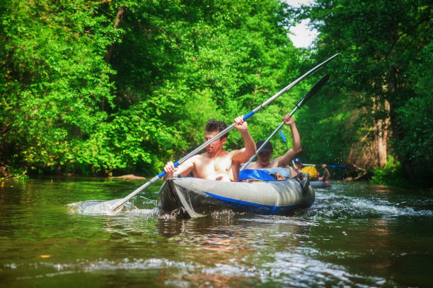 istock Kayaking in boat. Men rowing canoes. Rafting on river. 1096092396