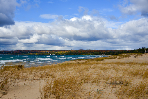 Dramatic sky and pounding surf at Petoskey State park outside of Petoskey, Michigan in autumn.