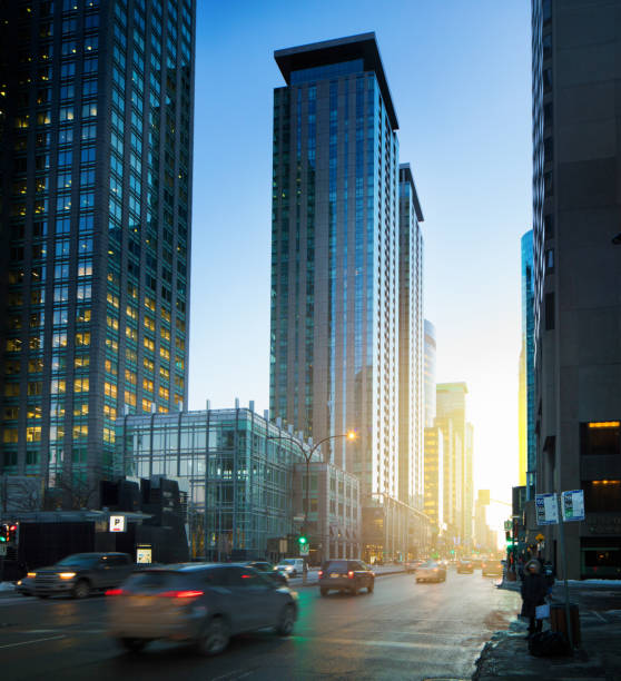 Downtown Montreal Winter scene at sunset with cars speeding by.
