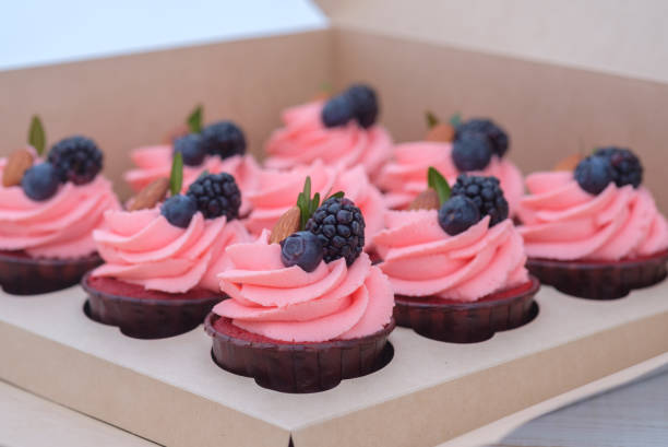 istock pink cream cupcakes in a cardboard box 1096108064
