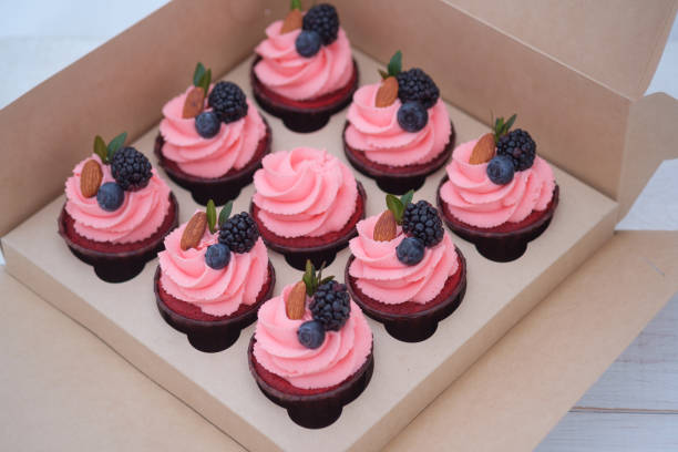 istock pink cream cupcakes in a cardboard box 1096108066