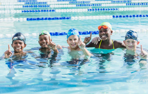 istock Multi-ethnic children in swimming pool smiling at camera 1096125612