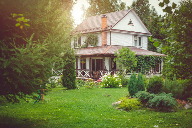 Country house with green back yard in sunny summer day Country cottage with green landscaped back yard in sunny summer day show garden stock pictures, royalty-free photos & images