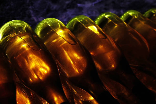 istock Rows of backlit wine bottles in winery cellar 1096131446