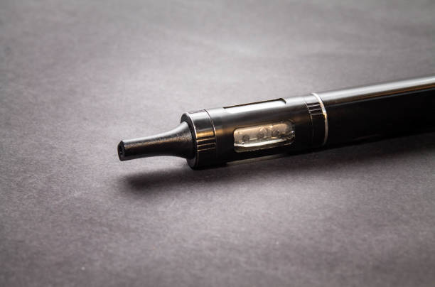 istock electronic cigarette vaporizer close on isolated on dark background 1096136418