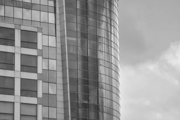 istock Modern building with reflected sky and cloud in glass window. Black and white. 1096139950