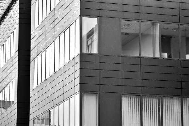 istock Modern building with reflected sky and cloud in glass window. Black and white. 1096143816