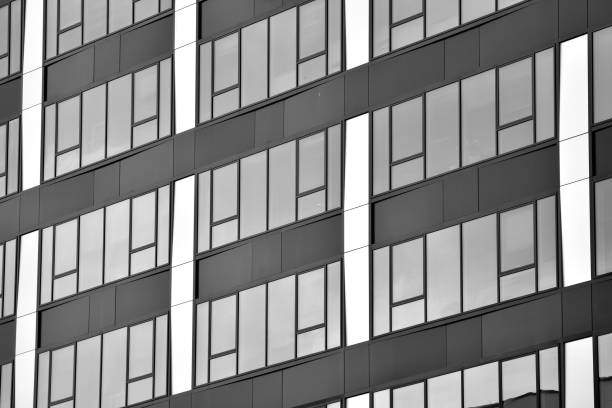 istock Modern building with reflected sky and cloud in glass window. Black and white. 1096145786