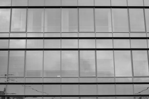 istock Modern building with reflected sky and cloud in glass window. Black and white. 1096145880