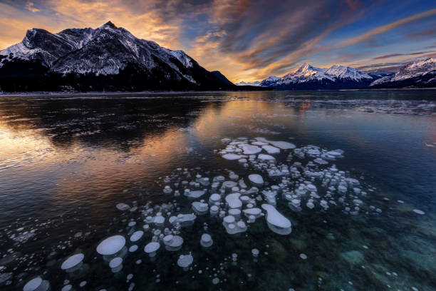 istock Sunrise with ice bubbles, Abraham Lake, Clearwater County, AB, Canada. 1096146972