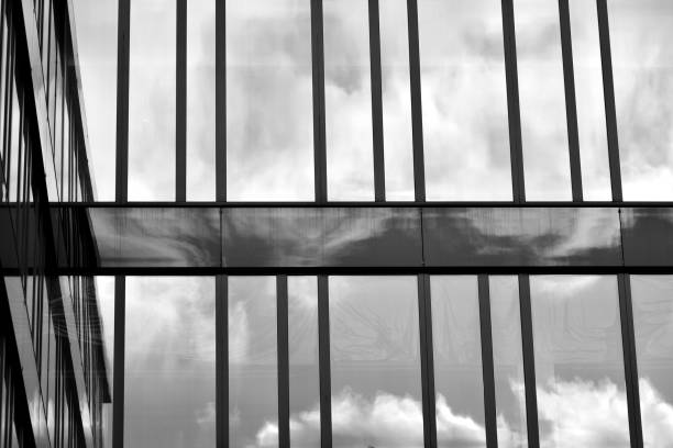 istock Modern building with reflected sky and cloud in glass window. Black and white. 1096147204
