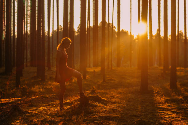 istock Young girl in evening forest 1096149400